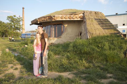 Tatjana and Dragan by their 'hobbit' house.