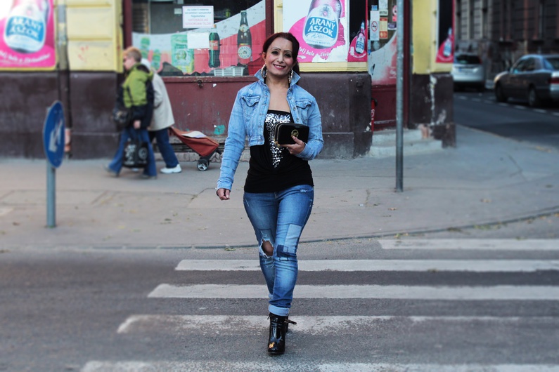 A young women crosses the street in the historically poorer area